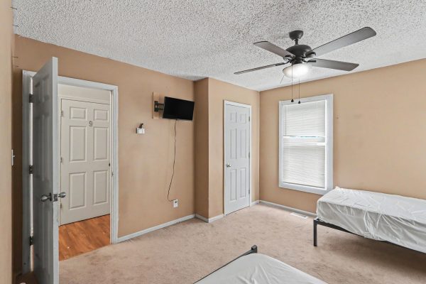 Haven North bedroom with two beds and ceiling fan